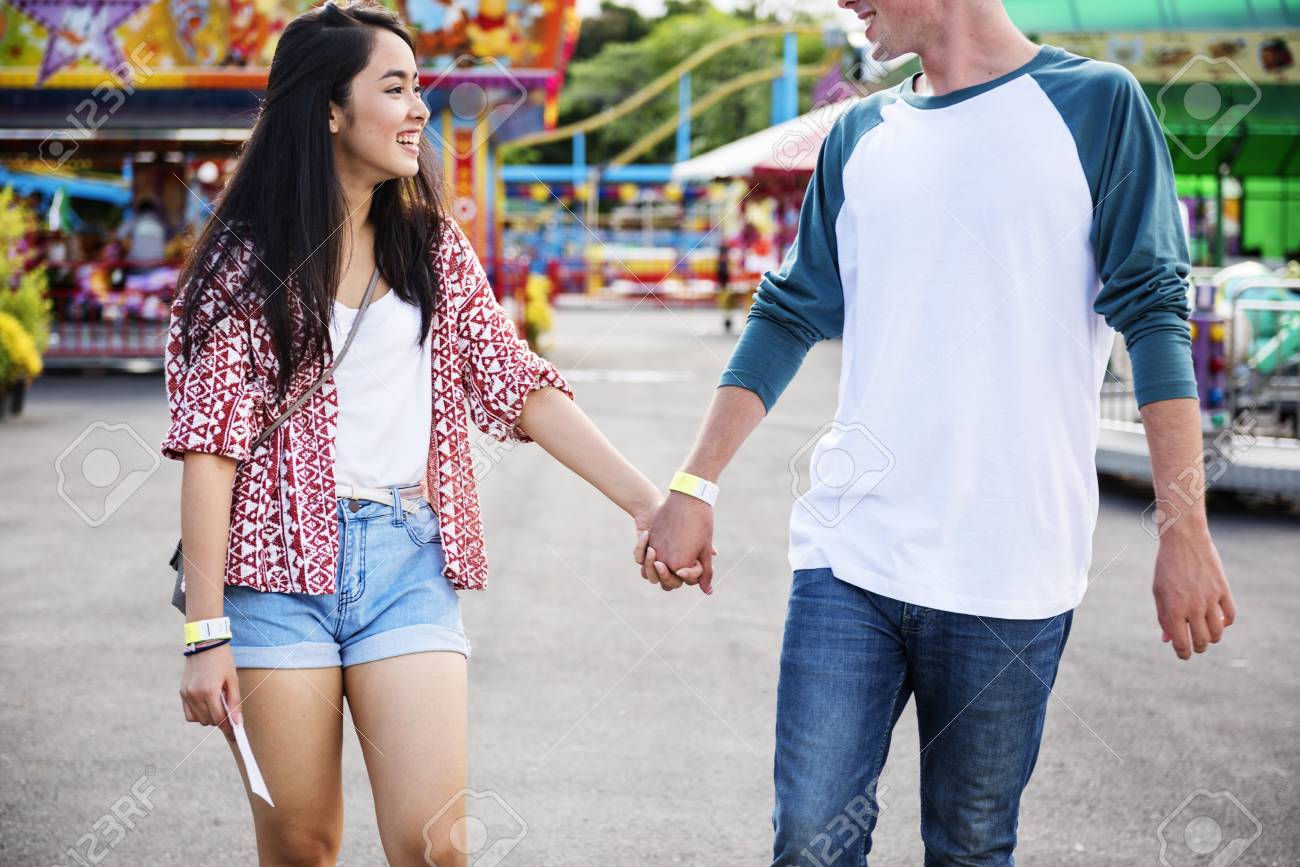 couple dating amusement park funfair festive playful happiness c